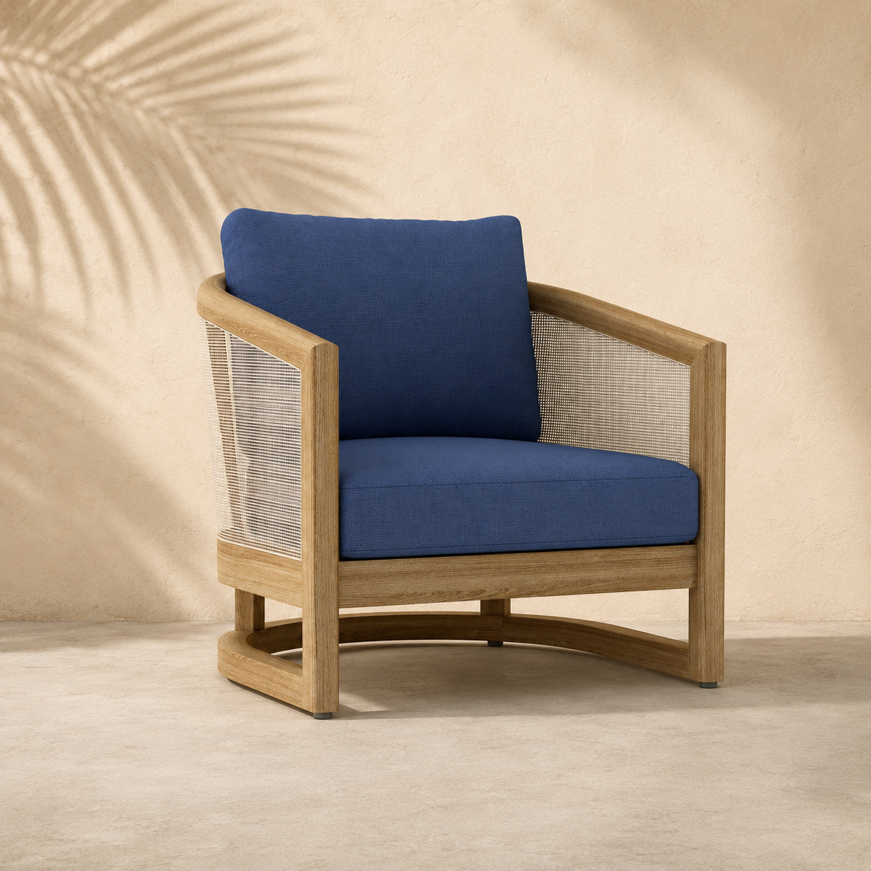 Wooden armchair with blue cushions against a beige wall with palm leaf shadows