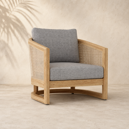 Wooden armchair with gray cushions on a neutral background