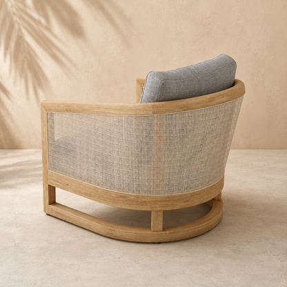 Wooden armchair with woven backrest and gray cushion on a beige background