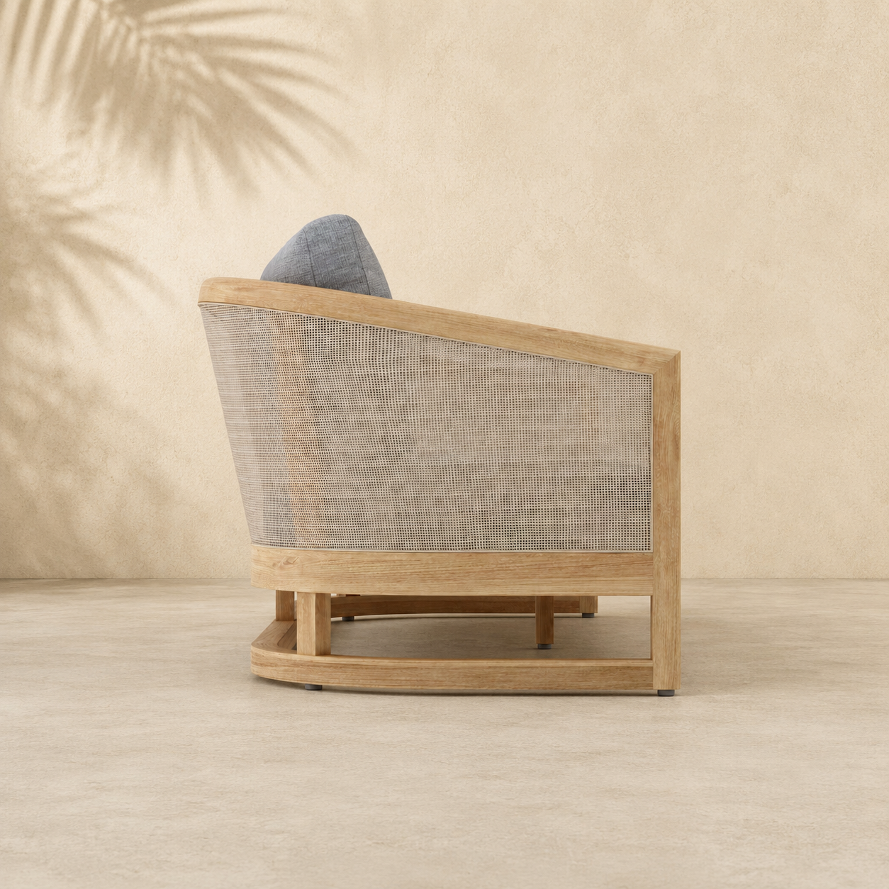 Wooden armchair with woven backrest against a beige wall