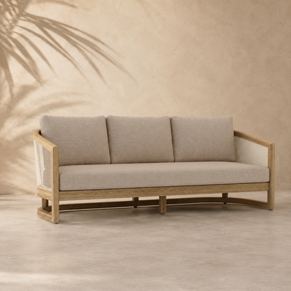 Beige sofa with wooden frame against a beige wall