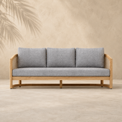 Gray sofa with wooden frame against a beige wall