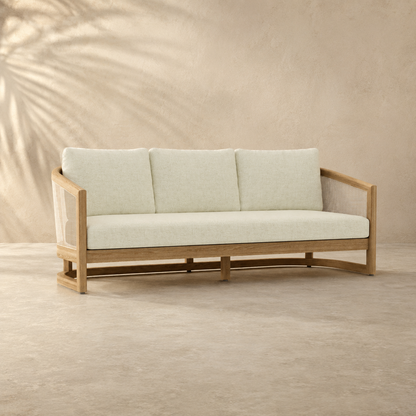 Beige sofa with wooden frame against a beige wall