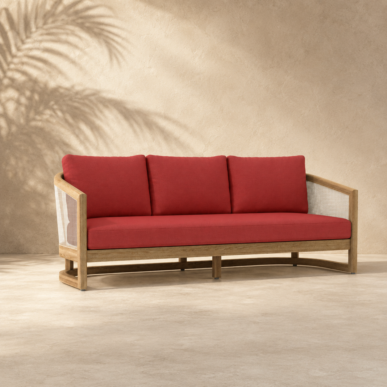 Red cushioned sofa with wooden frame against a beige wall