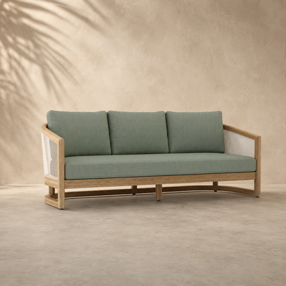Sofa with green cushions and wooden frame on a beige background
