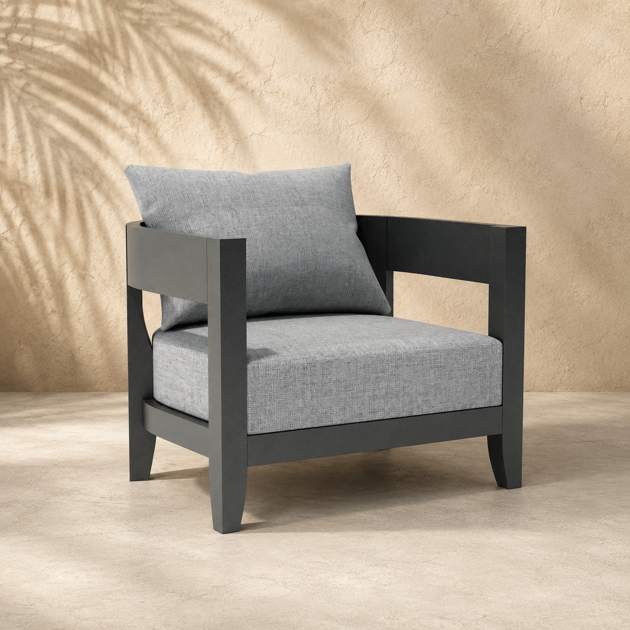 Gray armchair with a pillow on a beige background