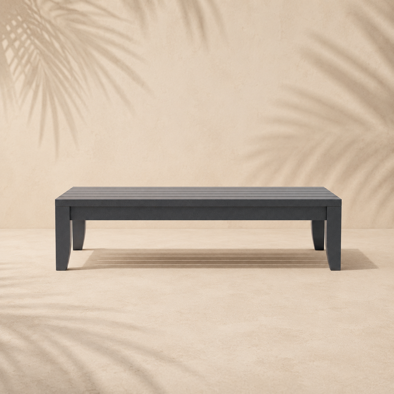 Gray bench on a beige background with palm leaf shadows