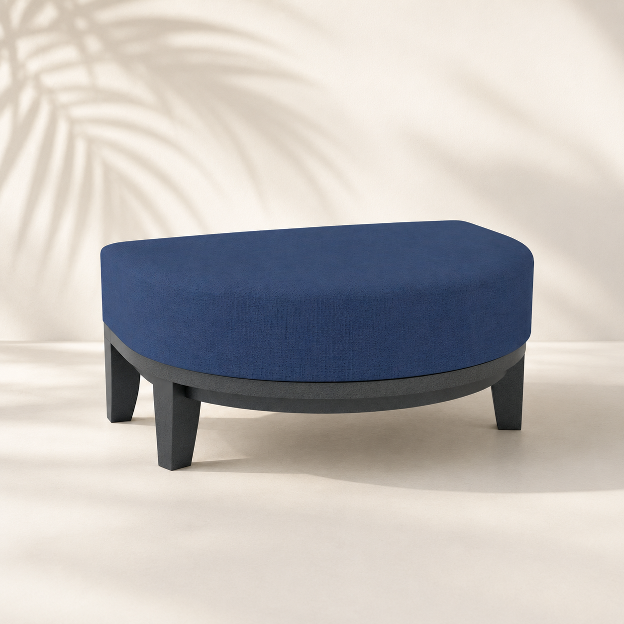 Blue ottoman with black legs on a neutral background