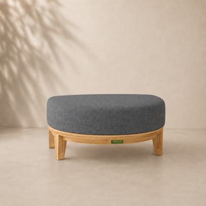 Gray upholstered stool with wooden legs on a beige background