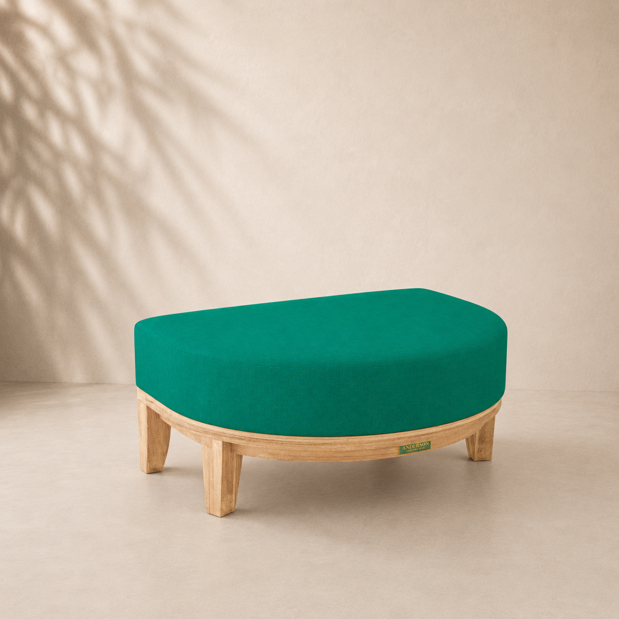 Teal ottoman with wooden legs on a beige background