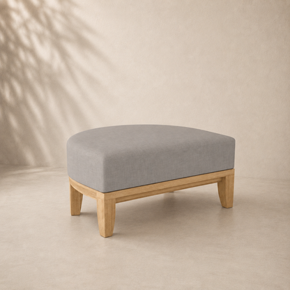 Stool with gray cushion and wooden legs on a beige background