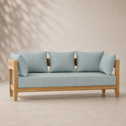 Light blue sofa with wooden frame against a beige background