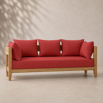Red sofa with wooden frame against a beige wall