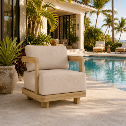 Beige outdoor chair with wooden frame by a poolside with palm trees in the background