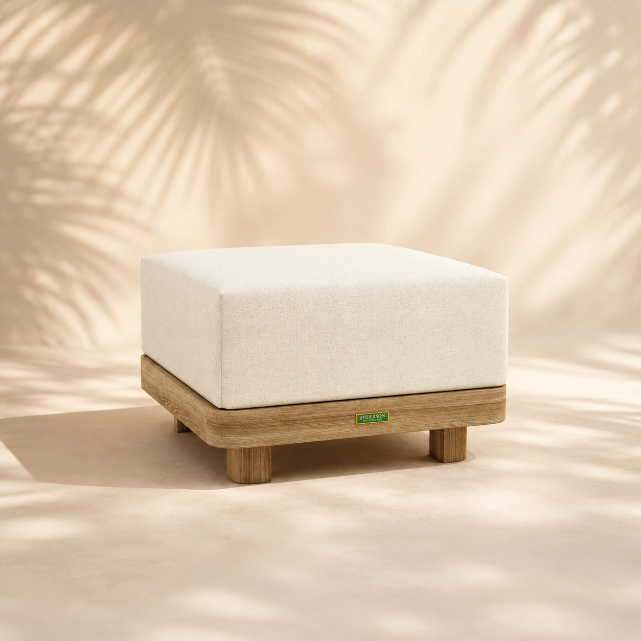 Square ottoman with white cushion and wooden base on a beige background